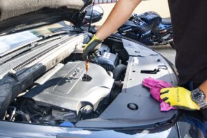 Man changing the oil in a car