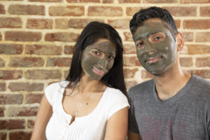 Woman and man with Elixir Mind Body Botanicals mud mask