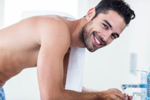 Man washing his face in the sink