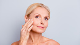Mature woman admiring her skin on her face