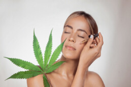 Woman using CBD oil on her face