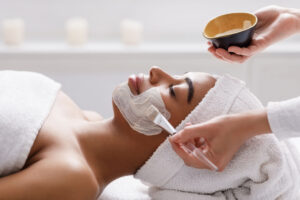 woman getting a relaxing facial at Elixir