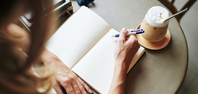 Creative woman filling journal