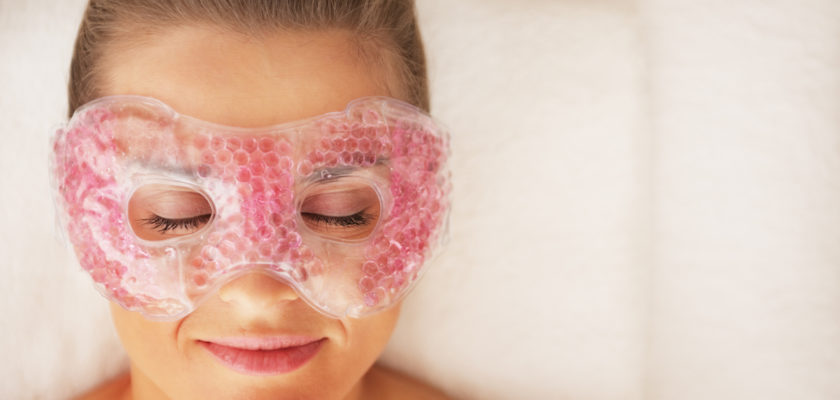 Woman using gel eye mask