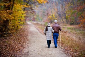 retired couple wwalking together in the fall