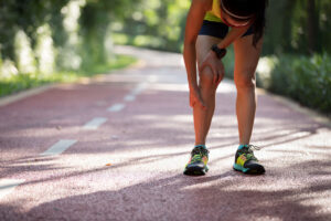 Female runner with muscle pull injury