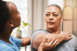 Massage therapist consulting with client about pain