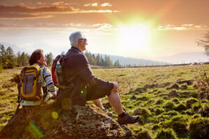 Mature couple on hike in mountians at sunset