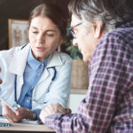 Female doctor going over treatment plan with male patient