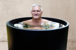 mature man in black cold plunge at Elixir Mind Body Massage