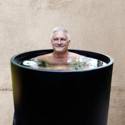 mature man in black cold plunge at Elixir Mind Body Massage