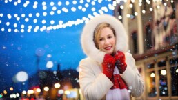 Woman in warm winter coat and red mittens downtown