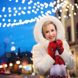 Woman in warm winter coat and red mittens downtown